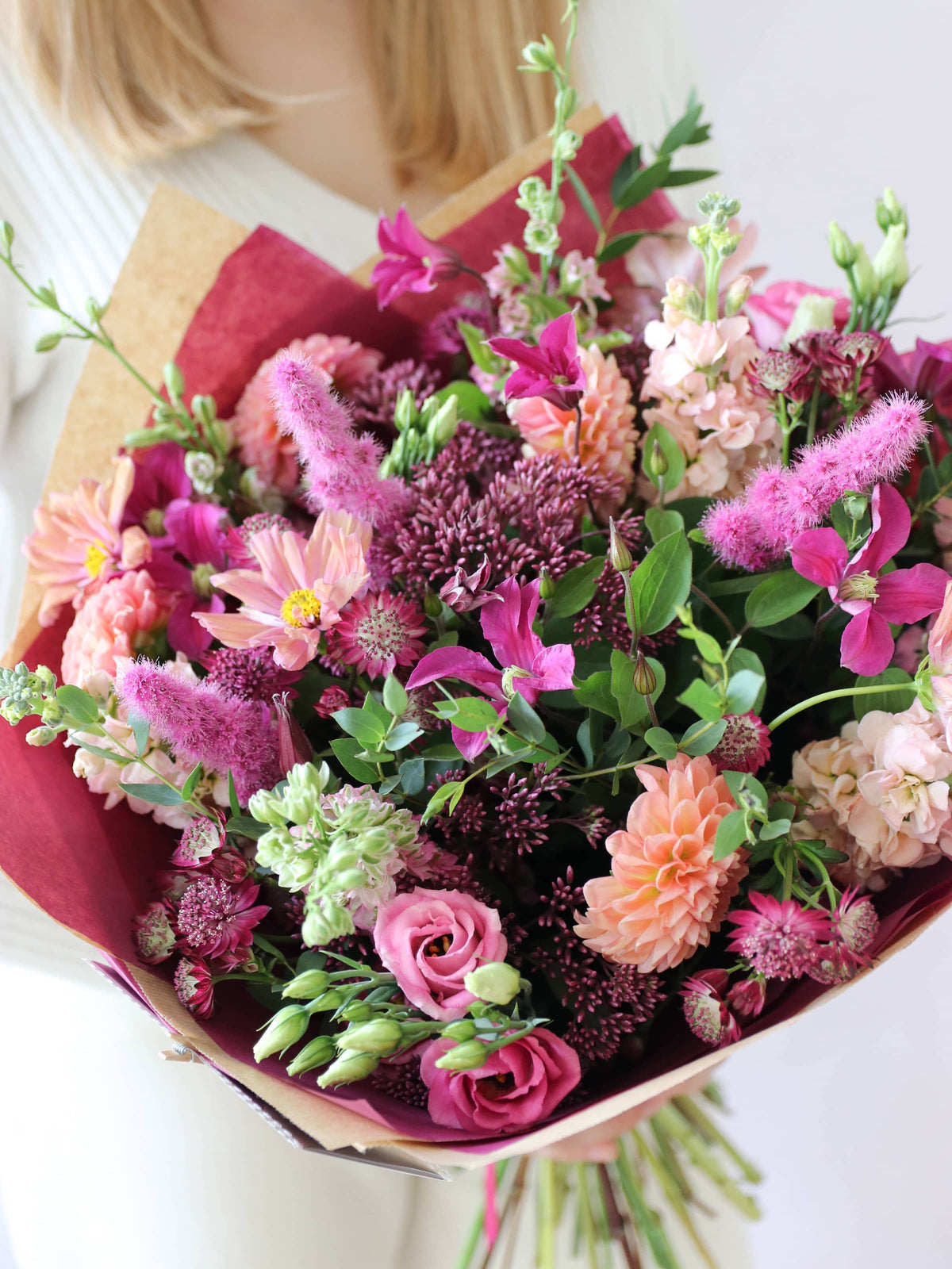Bouquet of bright pink and peach flowers with a white background