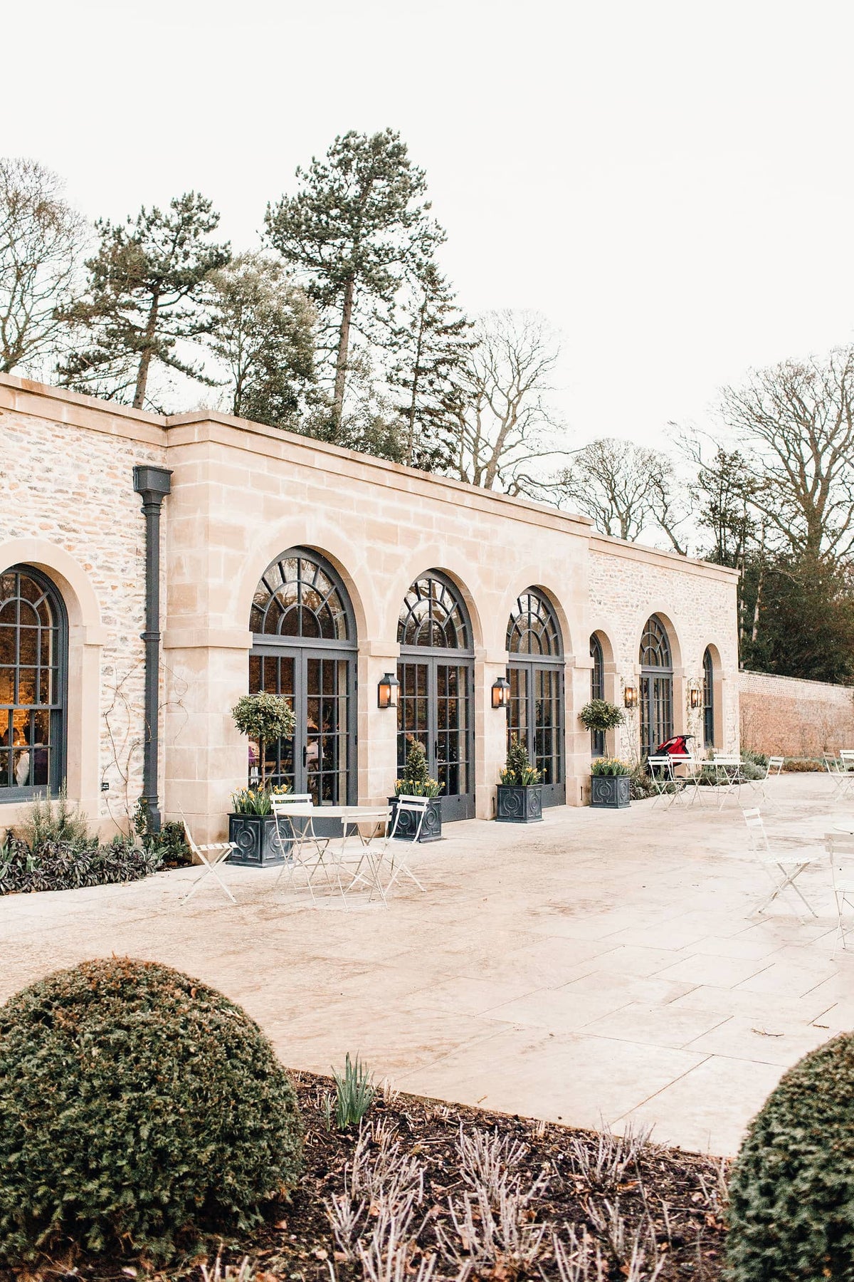 The Fig House at Middleton Lodge on a winter day in March with arched black doors and light colour brickwork.